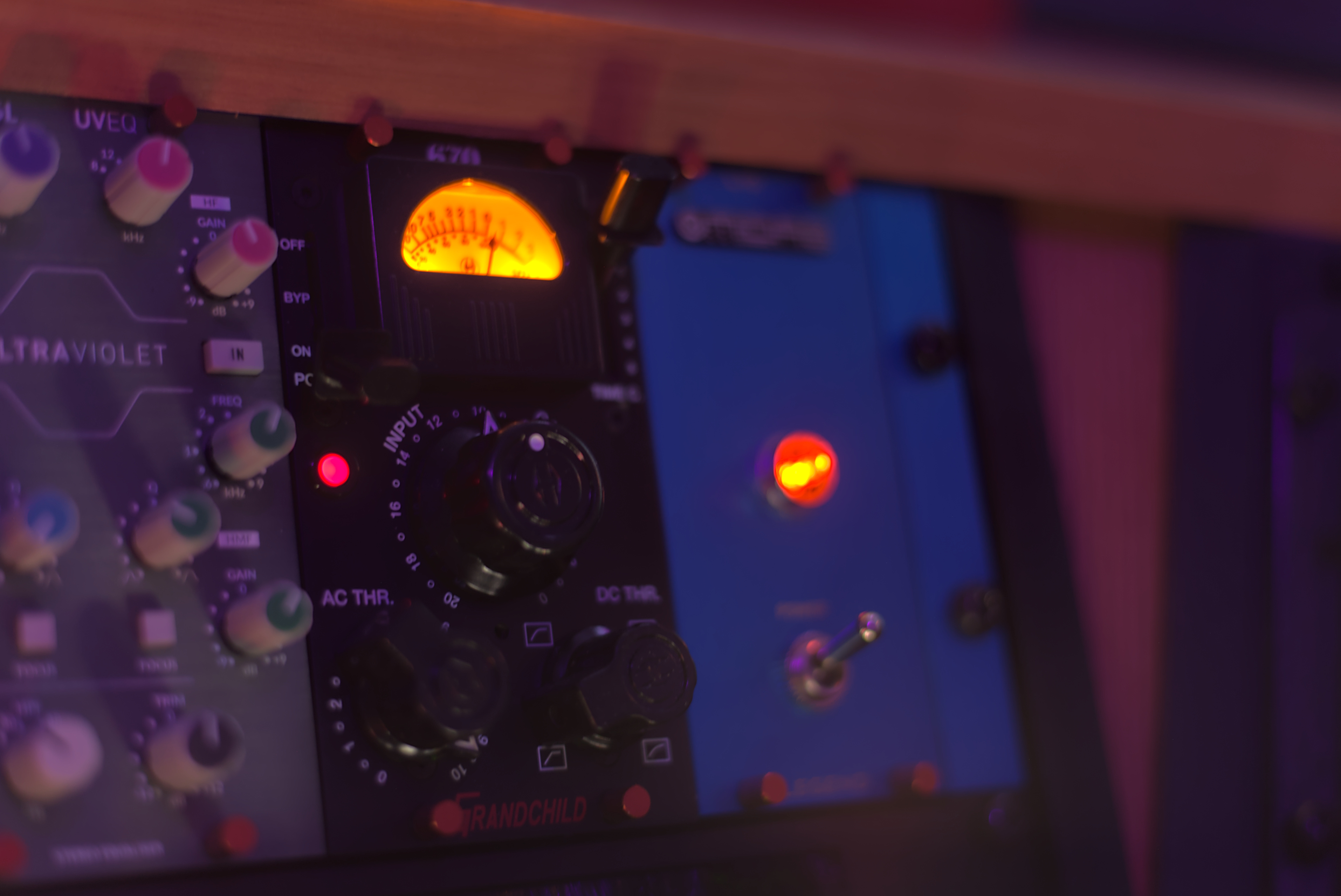 Close-up of Waveform Studio analogue outboard equipment with illuminated VU meter